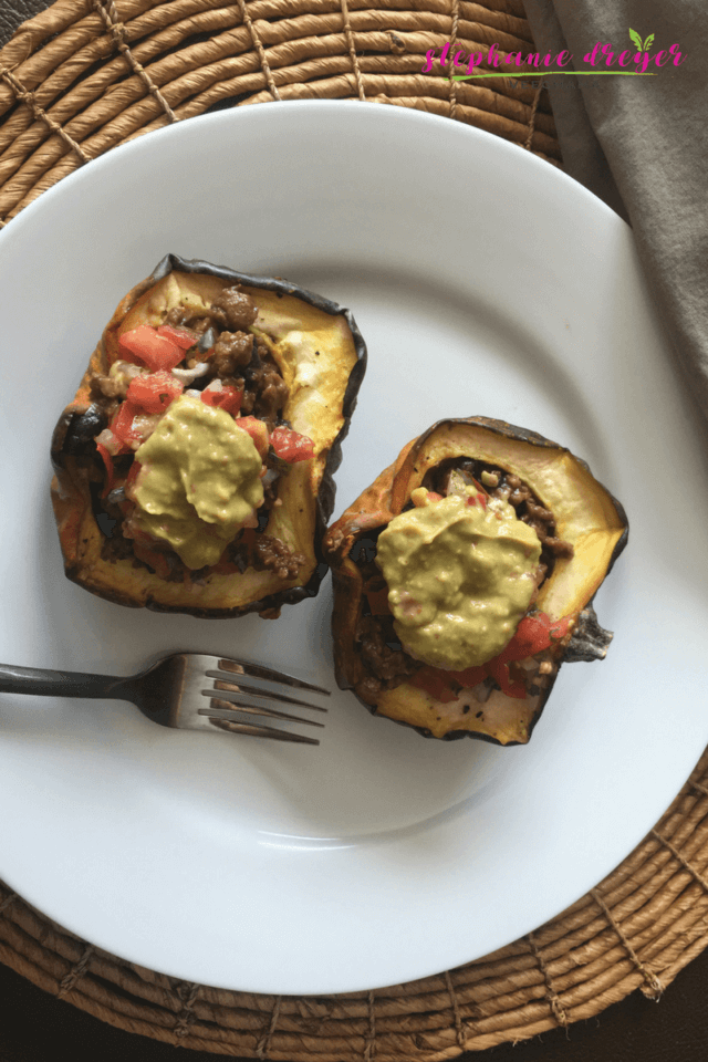 This plant-based Taco Stuffed Acorn Squash recipe is reminiscent of the flavors of Fall with the spicy taste of Taco Tuesday! #vegan #dairyfree #meatless