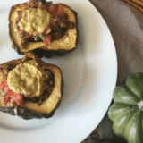 This plant-based Taco Stuffed Acorn Squash recipe is reminiscent of the flavors of Fall with the spicy taste of Taco Tuesday! #vegan #dairyfree #meatless