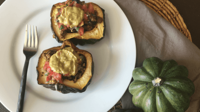 This plant-based Taco Stuffed Acorn Squash recipe is reminiscent of the flavors of Fall with the spicy taste of Taco Tuesday! #vegan #dairyfree #meatless