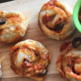 This Vegan Pizza Roll Ups are a fun twist on a kid favorite - pizza! Batch cook them on the weekend and serve with more pizza sauce for dunking. Fun and delicious!