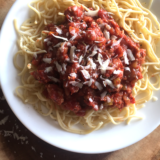 This Tempeh Bolognese is the only way I can get my kids to eat tempeh. It's crumbled in a rich tomato sauce with onion, garlic and veggies and simmered until tasty! Serve over your favorite pasta for an easy meatless weeknight meal.