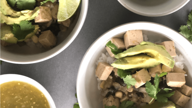 This Tofu Salsa Verde is a Mexican inspired green rice bowl featuring tomatillo salsa, black beans and extra firm tofu. Topped with avocado, cilantro and lime wedges, this is delicious comfort food served straight from the slow cooker or instant pot.