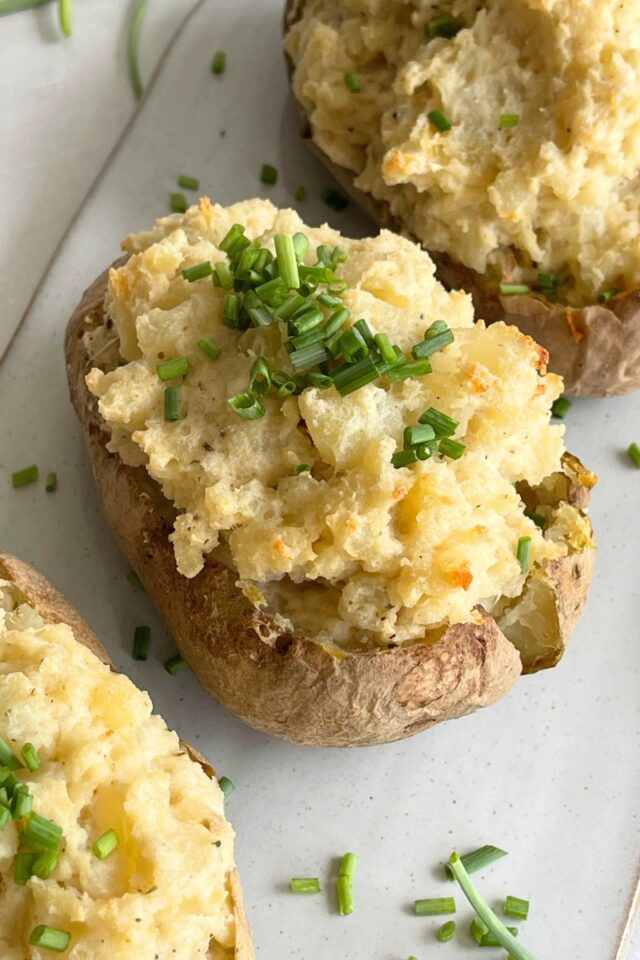 Close up shot of a stuffed baked potatoes on a white serving chair