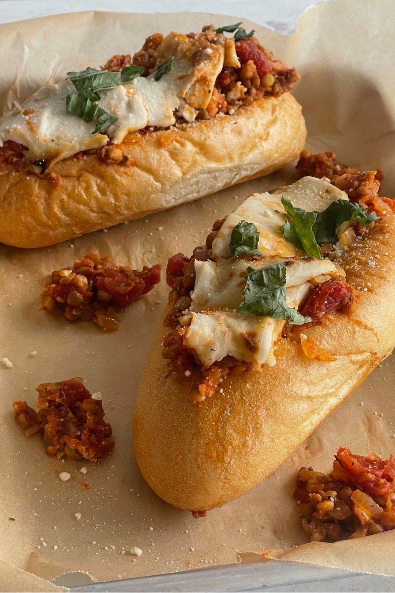 two bolognese subs on parchment paper