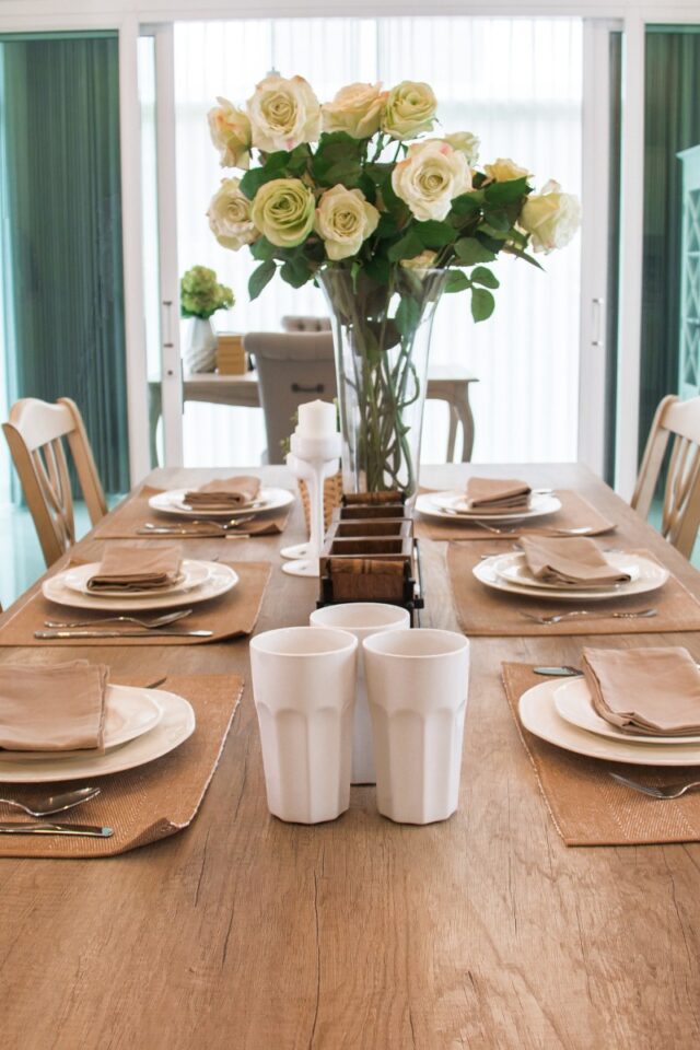 table set for dinner with flowers on it