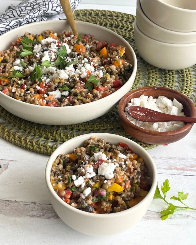 two bowls of lentil salad with a bowl of feta next to it