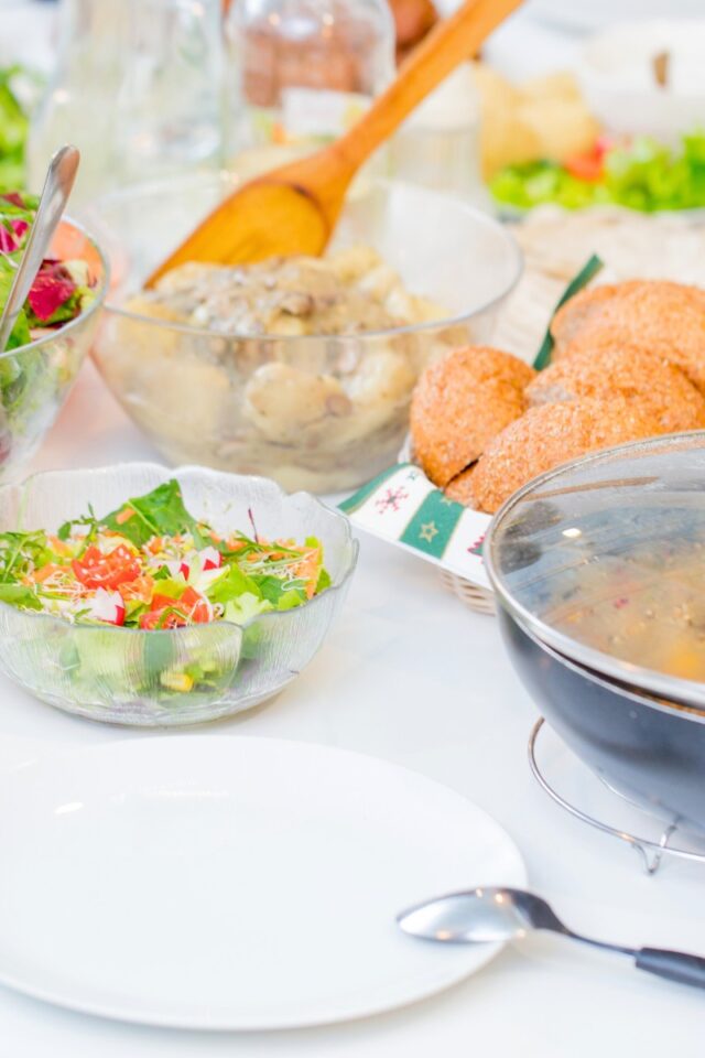 dinner table with serving bowls of food on it