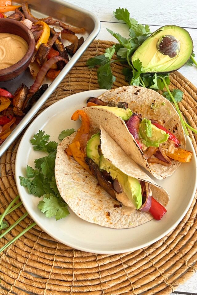 plate of tacos next to a sheet pan meal