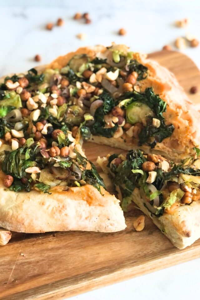 Full pizza on a wood cutting board