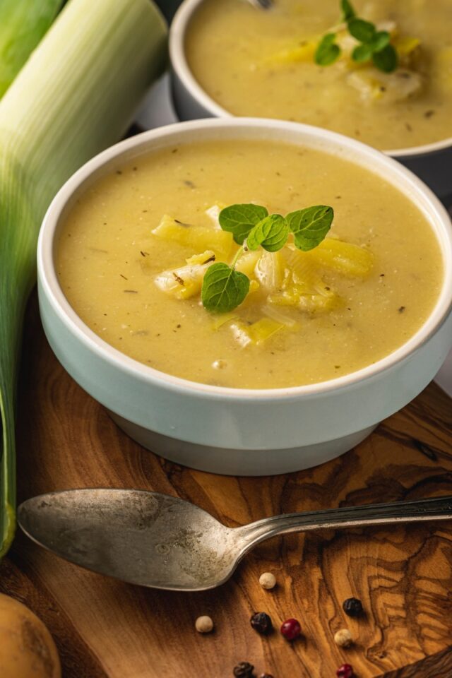 two bowls of potato soup on a table