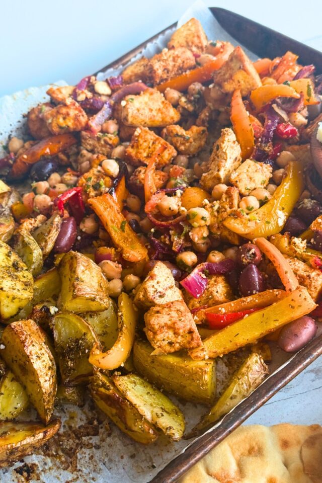 sheet pan with tofu, peppers and potatoes on it