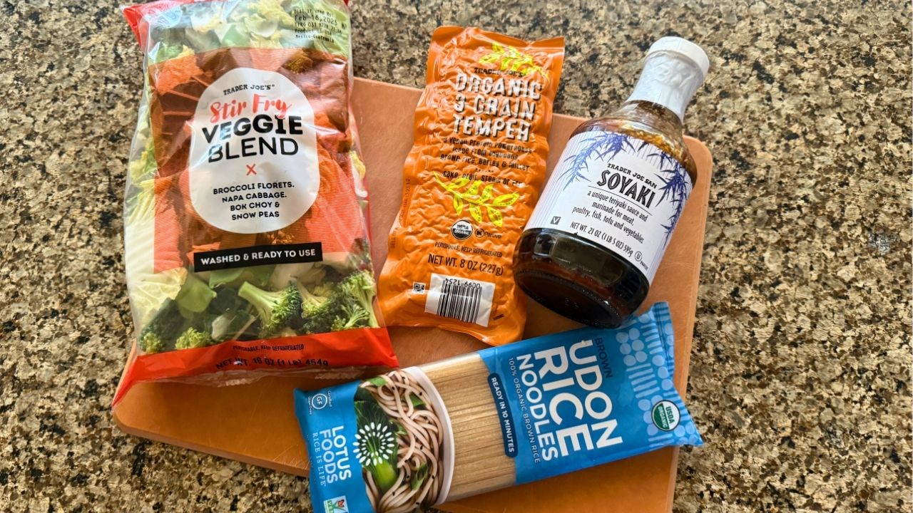 wood cutting board on a counter with stir fry ingredients on it